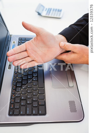 Hand of man touching his wrist Hand of man touching his wrist 12839376