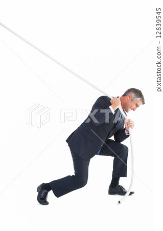 Classy businessman pulling a rope Classy businessman pulling a rope 12839545