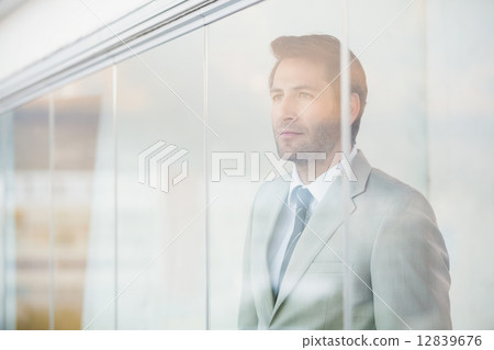 Portrait of thoughtful businessman through the window 12839676