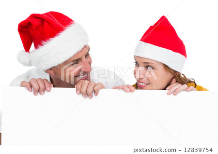 Festive couple showing a poster Festive couple showing a poster 12839754