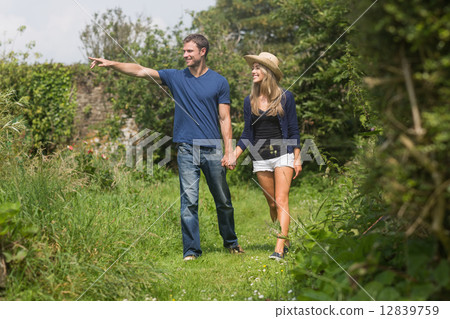 Cute couple walking holding hands Cute couple walking holding hands 12839759