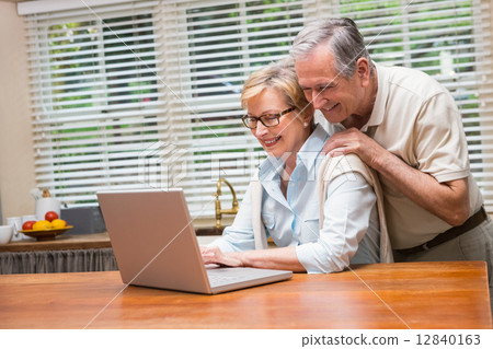 Senior couple using the laptop together Senior couple using the laptop together 12840163