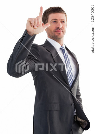 Serious businessman standing and pointing Serious businessman standing and pointing 12840303