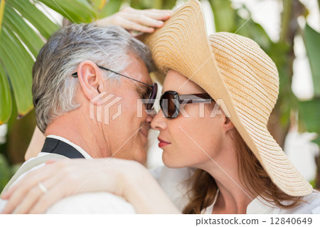 Holidaying couple hugging and smiling Holidaying couple hugging and smiling 12840649