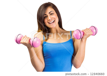 Smiling fit brunette holding dumbbells 12840660