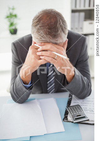 Stressed businessman with head in hands Stressed businessman with head in hands 12840858