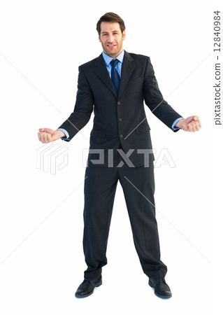 Happy businessman standing clenching his fists 12840984