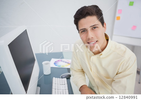 Handsome businessman smiling at camera 12840991