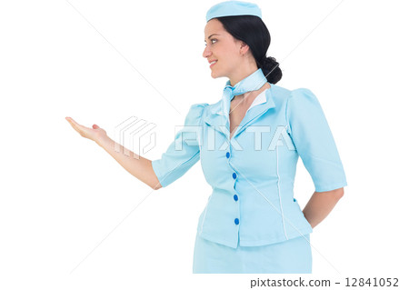 Pretty air hostess presenting with hand 12841052