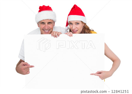 Festive couple showing a poster Festive couple showing a poster 12841251