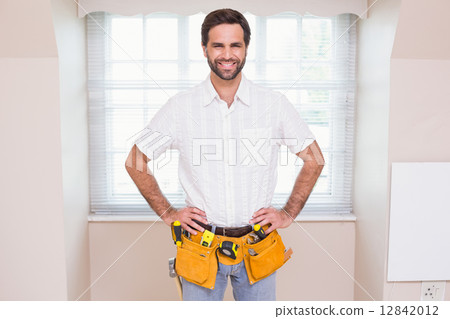 Handyman smiling at camera in tool belt 12842012