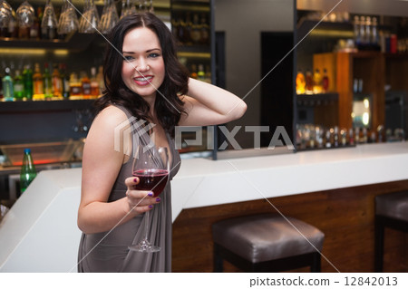 Pretty brunette enjoying red wine 12842013