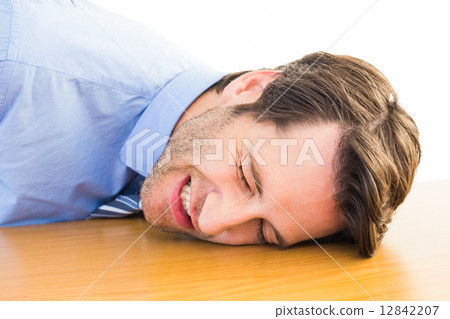Casual businessman sleeping at his desk 12842207