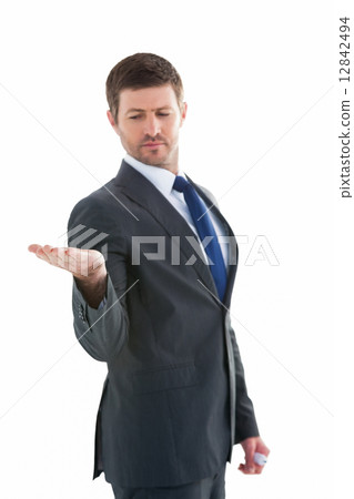 Businessman holding hand out in presentation Businessman holding hand out in presentation 12842494