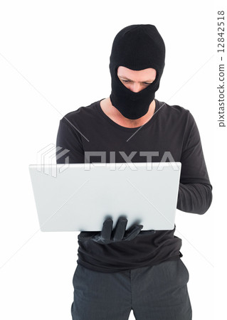 Hacker using laptop to steal identity Hacker using laptop to steal identity 12842518