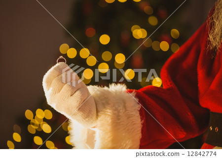 Hand of santa claus holding engagement ring 12842774