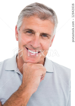 Casual man smiling with hand on chin 12842816