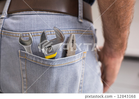 Handyman with tools in back pocket 12843168