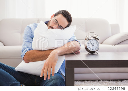 Exhausted man sleeping with head resting on pillow Exhausted man sleeping with head resting on pillow 12843296