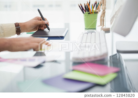 Designer working at desk using digitizer Designer working at desk using digitizer 12843820