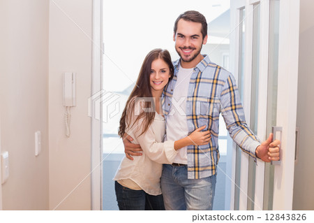 Cute couple walking through the door Cute couple walking through the door 12843826