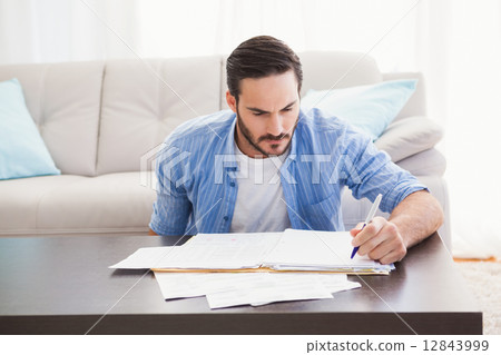 Focused man paying his bills 12843999