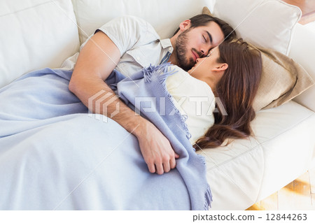 Cute couple napping on couch Cute couple napping on couch 12844263