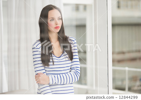Pretty brunette looking out window Pretty brunette looking out window 12844299