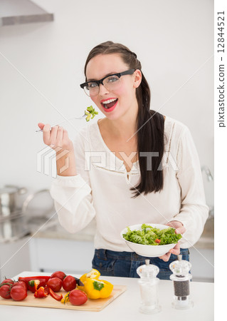 Pretty brunette preparing a healthy salad Pretty brunette preparing a healthy salad 12844521