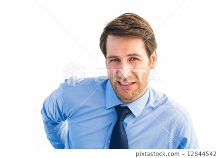 Handsome businessman with back pain standing Handsome businessman with back pain standing 12844542