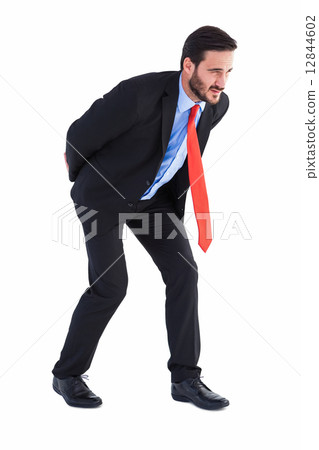 Businessman in suit carrying something heavy Businessman in suit carrying something heavy 12844602