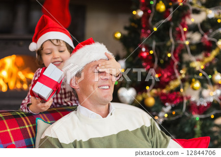 Son surprising his father with christmas gift 12844706
