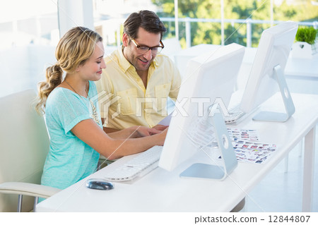 Photo editors choosing photos on computer screen Photo editors choosing photos on computer screen 12844807