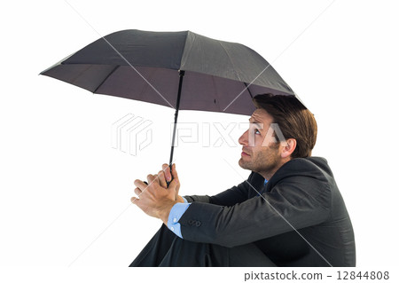 Businessman holding umbrella sitting on the floor Businessman holding umbrella sitting on the floor 12844808