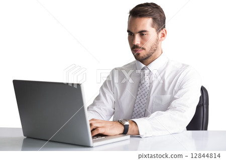 Cheerful businessman using laptop at desk Cheerful businessman using laptop at desk 12844814