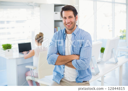 Portrait of handsome smiling photo editor with arms crossed Portrait of handsome smiling photo editor with arms crossed 12844815