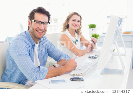 Attractive designers smiling at camera Attractive designers smiling at camera 12844817