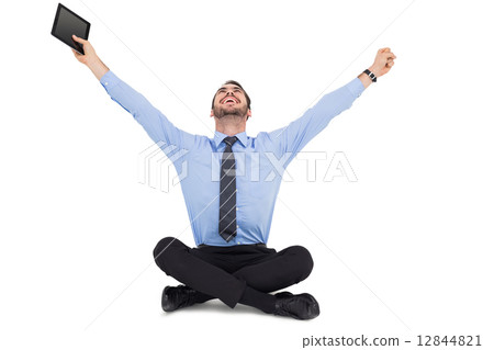 Businessman cheering and holding his tablet Businessman cheering and holding his tablet 12844821