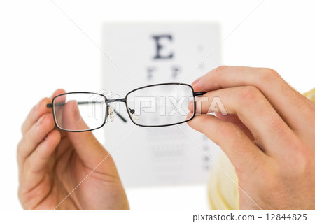 Glasses held up to read eye test 12844825