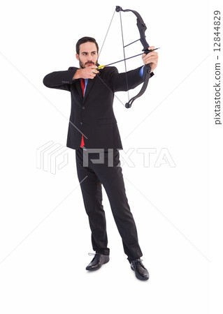 Focused businessman shooting a bow and arrow 12844829