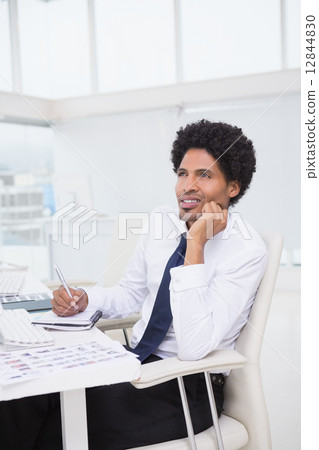 Handsome photo editor working at desk Handsome photo editor working at desk 12844830