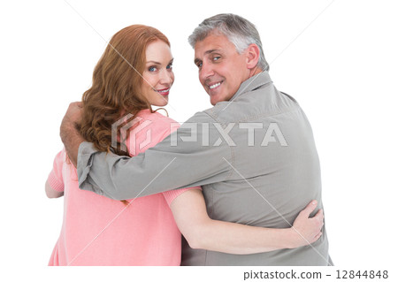 Casual couple standing arms around 12844848