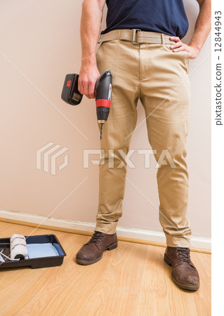 Construction worker holding power tool Construction worker holding power tool 12844943