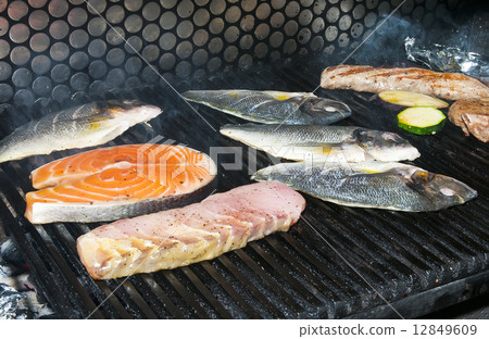 cooking fish on the grill in the restaurant cooking fish on the grill in the restaurant 12849609