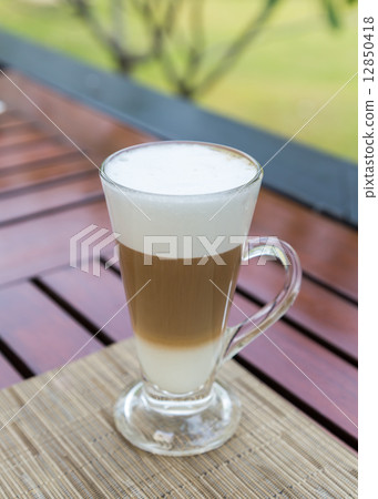 Latte macchiato in a glass with milk froth 12850418