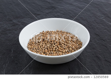 Coriander in a bowl on a slate Coriander in a bowl on a slate 12850569