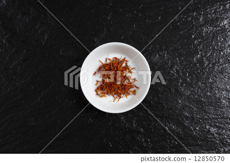 Saffron in a bowl on a slate Saffron in a bowl on a slate 12850570