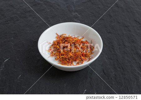 Saffron in a bowl on a slate 12850571