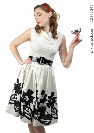 Image of woman looking down with metal snifter Image of woman looking down with metal snifter 12851345