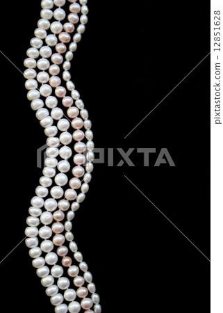 White and pink pearls on the black silk 12851628